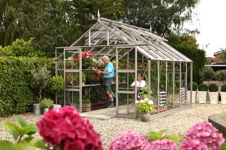Greenhouse next to green hedge